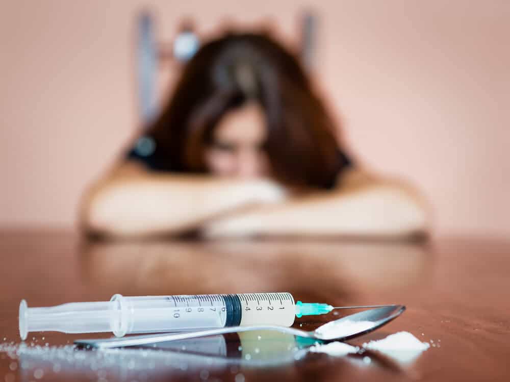 woman suffering from opioid use disorder and co-occurring disorders without mental health treatment is why relapse happens to her using heroin again