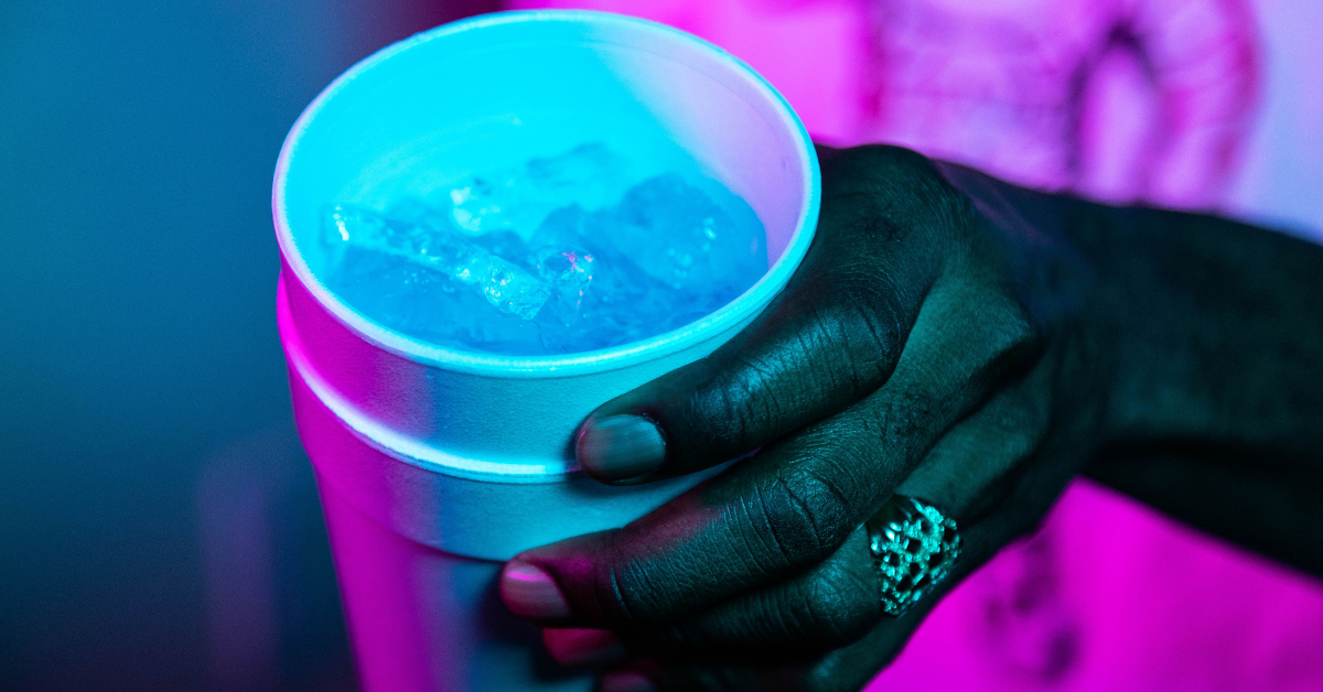 A hand holding a double stacked styrofoam cup